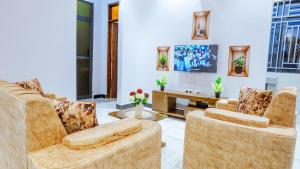 a living room with two chairs and a table at Cozycore Airnbn in Dodoma
