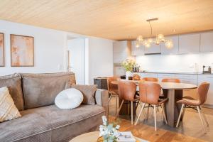 a living room and kitchen with a couch and a table at Casa Lago in Tüscherz-Alfermée +51 photos