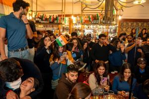 a crowd of people standing in a bar at Three Falcons in London