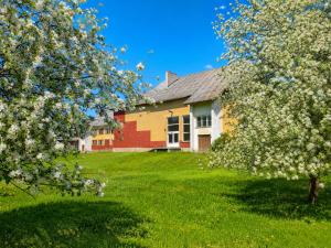 a house with flowering trees in the yard at Paide Event Center Hostel in Prääma