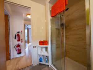 a shower with a glass door in a bathroom at Culver House Hotel in Port-Eynon +50 photos