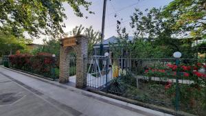 a wrought iron fence with flowers and plants at Garden Palace Khiva in Khiva