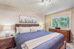 a bedroom with a large bed and two windows at Paintbrush Haven in Ronald