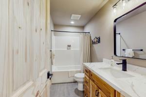 a bathroom with a sink and a toilet and a mirror at Paintbrush Haven in Ronald +31 photos