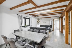 a dining room with a table and chairs at ANDRISS - Travel & Work - 5 BR - Kitchen - Parking in Kaiserslautern