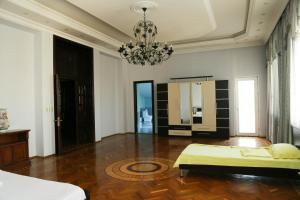 a bedroom with a bed and a chandelier at Premier Villas in Mardakan +42 photos