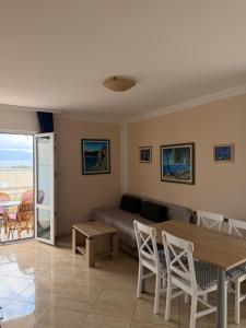 a living room with a couch and a table at Apartments Lončar in Gradac
