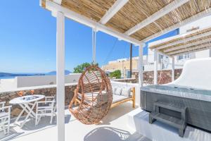 a swing on a balcony with a table and chairs at Plaka Suites in Plaka Milou