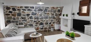 a living room with a stone wall at Antoni's House Makri in Alexandroupoli