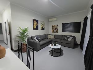 a living room with a couch and a table at CasaMari guesthouse in Pretoria