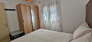 a small bedroom with a bed and a window at Antoni's House Makri in Alexandroupoli