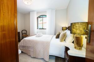 a bedroom with a white bed and a window at Casa Betania in Santa Cruz +55 photos
