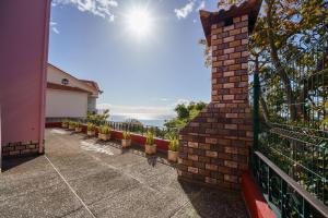 a wrought iron fence with a view of the ocean at Casa Betania in Santa Cruz