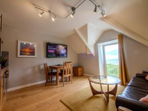 a living room with a couch and a table at Culver House Hotel in Port-Eynon
