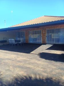 a building with a patio with a table and chairs at CasaMari guesthouse in Pretoria