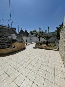 a courtyard with a tile floor and buildings at Charming Trulli in Alberobello