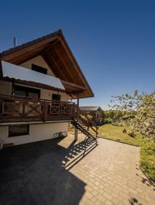a house with a porch and a balcony at Przystanek Borucino in Borucino