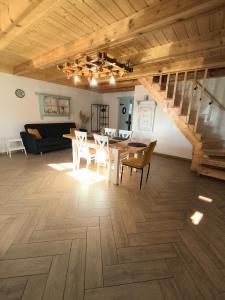 a dining room with a table and chairs and a staircase at Przystanek Borucino in Borucino