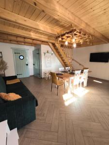 a living room with a couch and a table and chairs at Przystanek Borucino in Borucino