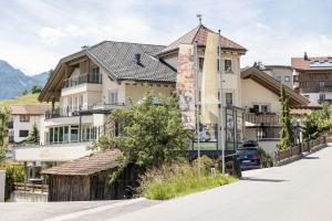 a building on the side of a street at ALPENAPART Ladis - Premium Family Apartments in Ladis