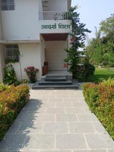 a walkway leading to the front door of a house at Aadarsh villa in Daulatābād