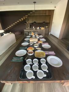 a long table filled with plates and bowls of food at Cinnamon Sunset Villa in Kurunegala