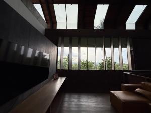 a living room with a large window with skylights at Cinnamon Sunset Villa in Kurunegala