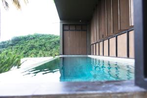 a swimming pool on the side of a building at Cinnamon Sunset Villa in Kurunegala