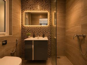 a bathroom with a sink and a toilet and a mirror at Spacious Townhouse - Private Jacuzzi -Swieqi in Is-Swieqi +18 photos