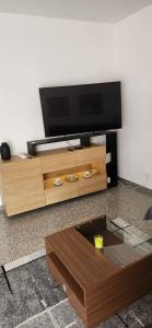 a living room with a tv and a coffee table at Casa Richiusa Calogero in Blufi