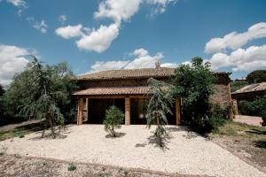 a house with trees in front of it at Malicodia in Santa Maria di Licodia