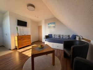 a living room with a bed and a table at Ostseekoje Koje 6 in Süssau