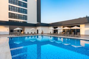 a large swimming pool in front of a building at RENEX HOTELS in Antalya
