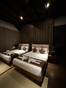 two beds in a room with people laying on them at Cinnamon Sunset Villa in Kurunegala +30 photos