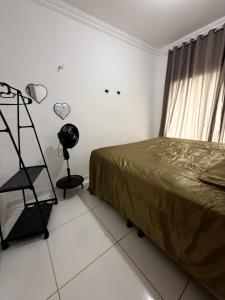 a bedroom with a bed and a shelf next to a window at Grace Palace in Paraipaba +27 photos