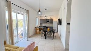 a kitchen and living room with a table and chairs at Pilone del Monaco Apartment 9 in Vieste