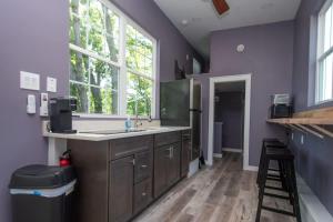 a kitchen with a sink and a purple wall at Greystone - Cozy 2-bedroom Tiny Home in soothing Anderson SC on Lake Hartwell in Anderson
