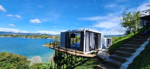 a tiny house on the side of a river at Lake Capsule in Horizonte