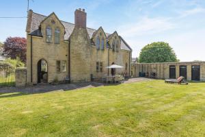 an old brick house with a lawn in front of it at 4 Bed in Bridport oc-58847 in Powerstock