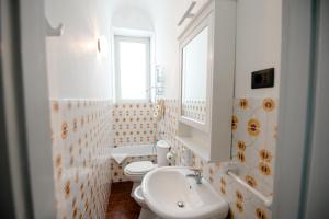 a white bathroom with a sink and a toilet at Malicodia in Santa Maria di Licodia +34 photos