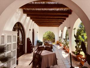 an arched hallway with a table and chairs in a house at Bed and Breakfast Tenuta Sicilia in Ostuni