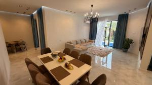 a living room with a table and chairs and a couch at ReVaN in Baku