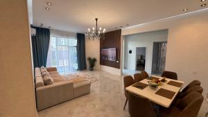 a living room with a couch and a table at ReVaN in Baku