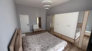 a bedroom with a bed and a large mirror at ReVaN in Baku +9 photos