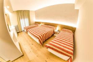 A bed or beds in a room at Grand Hotel Europa Rivisondoli Centro