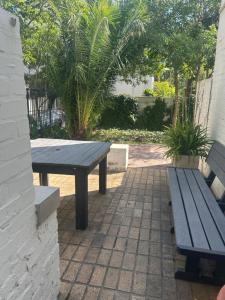 a picnic table and benches on a brick patio at Bosch & Bloom in Stellenbosch