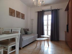 a living room with a couch and a window at Babis Apartments & Studios Iremia in Acharavi
