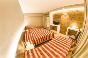 A bed or beds in a room at Grand Hotel Europa Rivisondoli Centro
