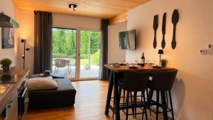 a kitchen and living room with a table and chairs at Apartment Relax - Stubenbergsee in Stubenberg