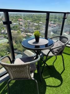 a table and chairs on a balcony with a view at Dream Apartment in Bila Tserkva